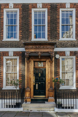 Fototapeta na wymiar Beautiful old brick building facade and entrance door in London, England