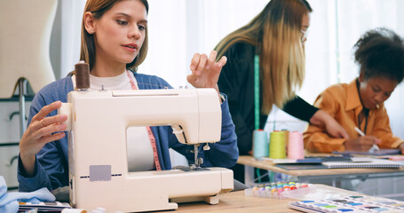 A group of young women are learning the profession of design and tailoring.