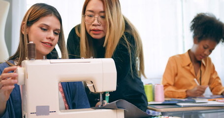 A group of young women are learning the profession of design and tailoring.