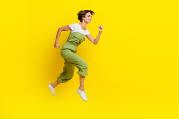 Profile body size photo of youngster playful girl fast runner empty space jump air deadline for weekend empty space isolated on yellow color background