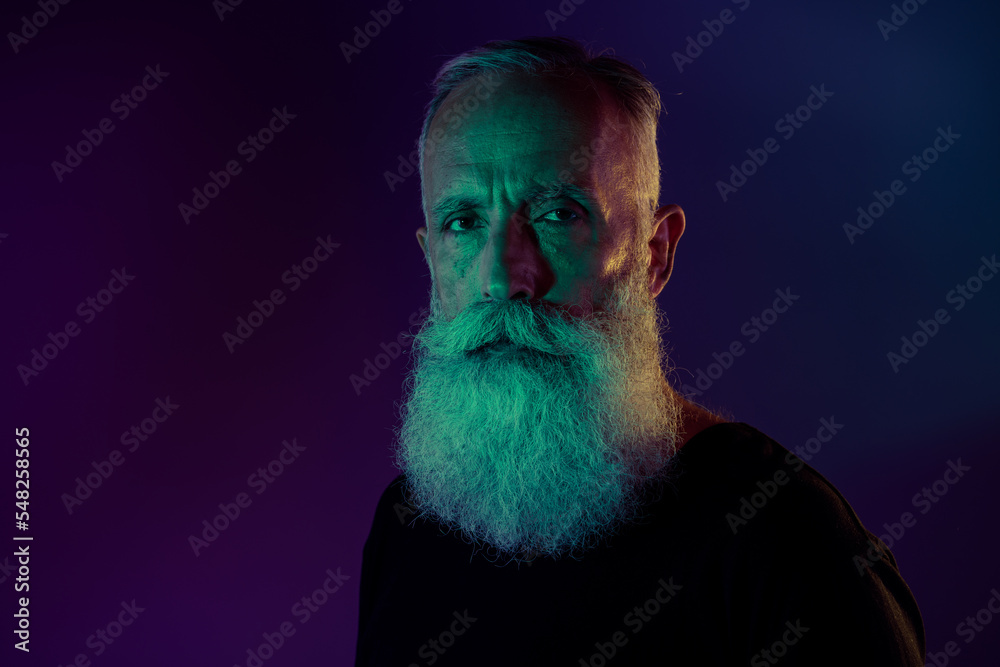 Wall mural Photo of virile handsome retired man dressed black pullover looking you empty space isolated dark green purple color background