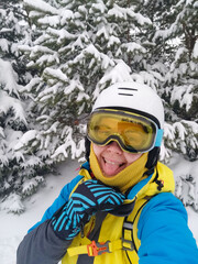 Fototapeta na wymiar smiling woman taking selfie in ski equipment