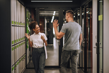 Joyful office worker saying hello to her coworker © Oleksandr