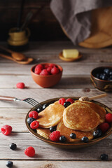 Pancakes with berries in rustic style	