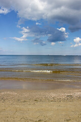 seascape. sandy seashore, sea and cloudy sky