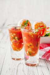 delicious summer gazpacho cocktail on a white wooden rustic background