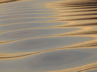 water forming beautiful pattern and reflecting evening sun light