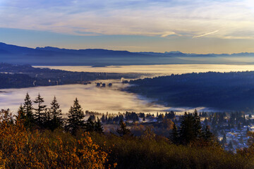 Obraz premium Upper floors of high-rise condominiums poking through Fall cloud inversion over Fraser Valley, BC, Canada 