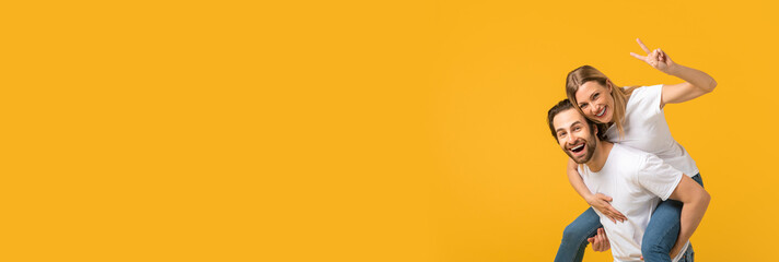 Positive Couple Having Fun And Showing Peace Gesture At Camera, Long Shot