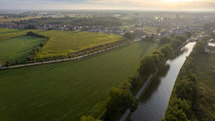 Land or landscape of green field in aerial view. Include agriculture farm, house building, village....