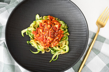 Homemade zucchini spaghetti with vegan bolognese sauce made with textured soy