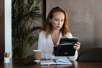 Close up of young woman looking at cosmetic bag