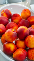 Fresh raw fruits, peaches on a modern white kitchen table. Healthy eating. Organic food.