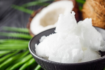 fresh natural coconut butter on black wooden background
