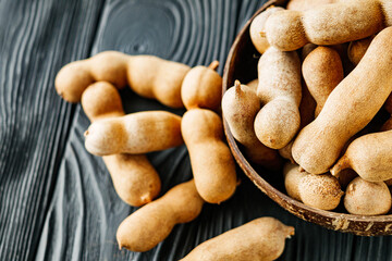 sweet and sour tamarind on a black rustic wooden background