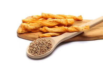 butter pastry twists with emmental cheese and cheddar cheese on chopping board and spelt grain in wooden spoon isolated on white