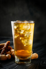 tamarind juice cooling drink on black rustic wooden background tea