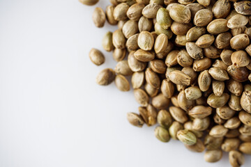 natural hemp seeds on a white acrylic background
