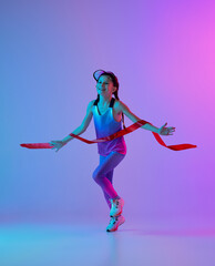 Winner emotions. Happy female junior runner in stylish sportswear and cap running isolated on gradient pink-blue background with neon light. Concept of sport, fashion, fitness and education