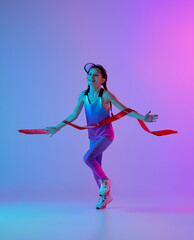 Winner emotions. Happy female junior runner in stylish sportswear and cap running isolated on...