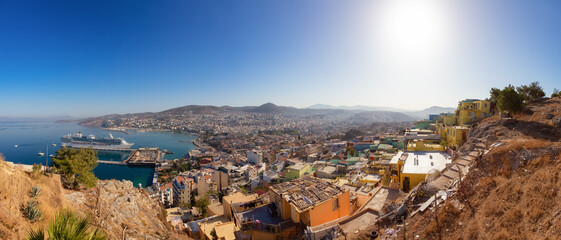 Obraz premium Homes and Buildings in a Touristic Town by the Aegean Sea. Kusadasi, Turkey. Sunny Morning Sunrise. Top of Hill. Panorama