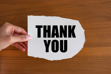 Thank you - close up text on the slip. Woman hand holds a piece of paper with text. Gratitude,...