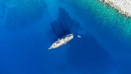 Drone footage of a boat in the cristal clear sea
