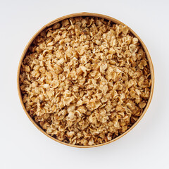 fresh raw buckwheat flakes on a white background