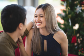 Naklejka premium Two Asian young people cute couple husband guy wife lady drink hot beverage x-mas eve spend time magic land newyear, Christmas celebrate in romantic love together with family, happy holiday concept