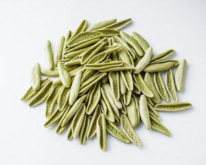 raw green cavatelli pasta on a white background