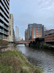 Fototapeta premium City view with buildings next to the river. Taken in Manchester City centre. 