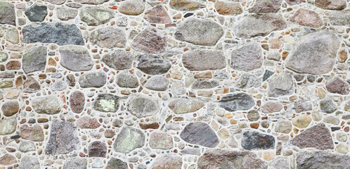 Rustic natural stone wall in panorama format.