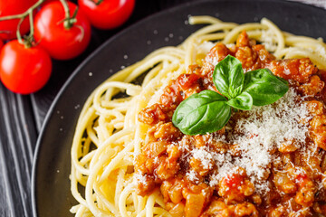 delicious Bolognese pasta on a black plate