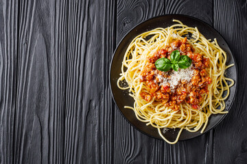 delicious Bolognese pasta on a black plate
