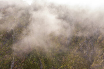 Fototapeta na wymiar Drone view of mountains buried in clouds