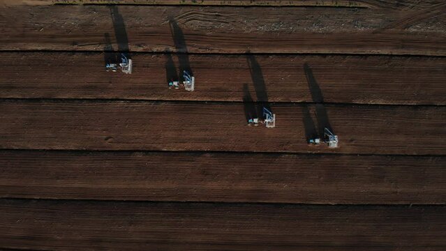 Drone shooting. Harvesting peat with combines. Peat extraction process. Agriculture industry.