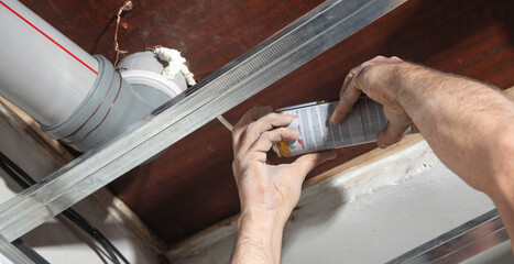 Worker using Polyurethane foam at home. - obrazy, fototapety, plakaty
