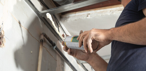 Worker using Polyurethane foam at home.