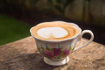 Cappuccino with frothy foam, vintage white cup coffeeon wood background. Flat lay style