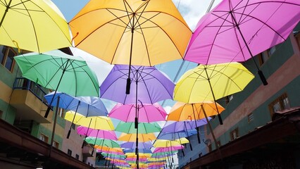 Fototapeta na wymiar Colombia , South America 2022 - Guatape is a little village close to Medellin tourist attraction - the downtown streets with Spanish colonial-style houses full colored umbrellas 
