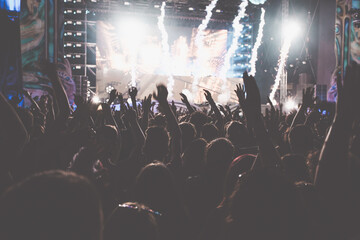 Crowd at concert and blurred stage lights.