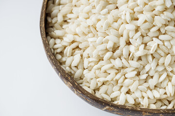 arborio rice for risotto on a white acrylic background