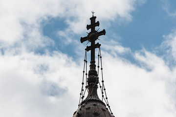 Fototapeta na wymiar Christian church cross placed on top on the roof against cloudy day