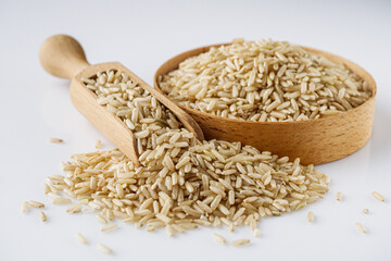 raw unpolished rice on a white acrylic background