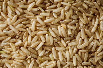 raw unpolished rice on a white acrylic background