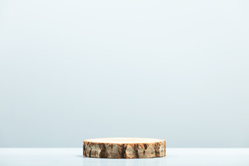 Wood slice podium on blue background for cosmetic product mockup