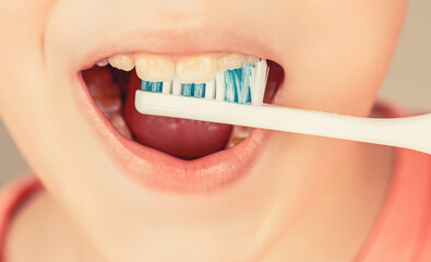 Kid boy brushing teeth. Boy toothbrush white toothpaste. Health care, dental hygiene