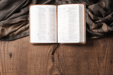 An open Bible on a wooden table, copyspace, flat lay bible
