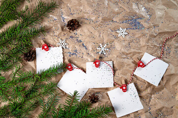 White notebooks on a New Year 's background . Happy New Year and Merry Christmas. New Year's goals or promises with colorful decorations on the background of crumpled kraft paper with Christmas tree
