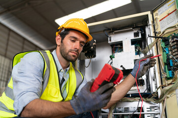 Robotics engineer working on maintenance of modern robotic arm in factory warehouse